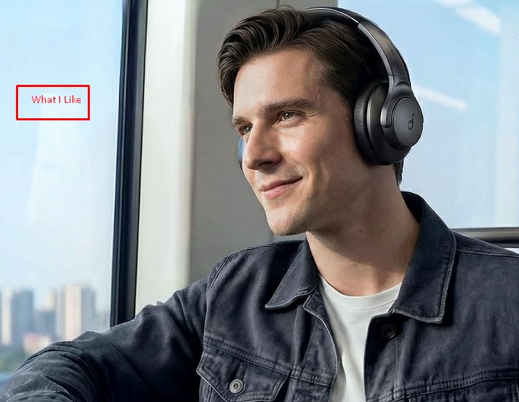 Man wearing Soundcore Q20i over-ear headphones while sitting by a train window
