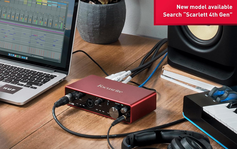 Scarlett 4i4 connected in a home studio setup with laptop, studio monitor and headphones